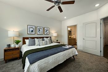 a bedroom with a large bed and a ceiling fan